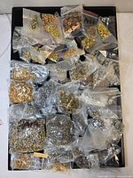 Full tray showing all clear bags of assorted metal hardware