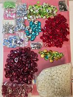 Wide view showing all bags of flat marbles and acrylic gems