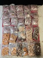 Grid of all sealed bags showing variety of shells and rose beads