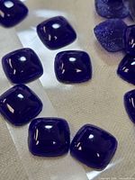 Close-up of individual cobalt pillow beads showing shape and finish