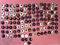 Overhead view showing full assortment of cabochons laid out on pink cloth