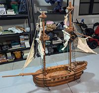 Starboard view of full wooden model sailboat on table