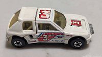 Side view of Hot Wheels white rally hatchback with racing decals and number 3