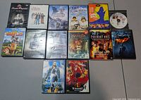 Full lot shot showing all 14 DVD cases and loose disc