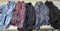 All five shirts laid out flat showing fronts and colours