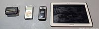 All four items side by side: pager, iPod, LG flip phone, Samsung tablet