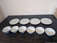 Overhead view of entire set showing four plates and six bowls
