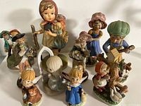Group shot of all ten ceramic child and angel figurines