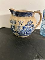 Left front view of Blue Willow pitcher showing pattern and shape