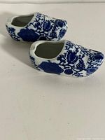 Two blue and white porcelain clogs with floral design