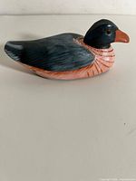 Side view of the wooden duck decoy showing carving and paint details