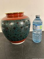Full view of vase next to water bottle for scale