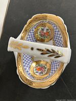 Top view showing interior lattice, floral medallions, gilt rim, handle detailing