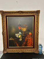 Full view of framed still life painting with water bottle for scale