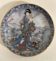 Front view of decorative plate with floral maiden artwork