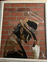 Full view of framed oil painting depicting Michael Jackson against brick background