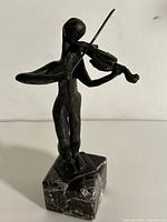 Full view of bronze violinist sculpture on marble base