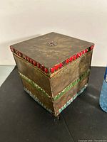 Full view of brass box showing lid and red glass cabochons