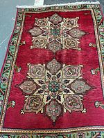 Full view of Persian wool rug showing overall design and borders