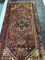 Full view of Persian rug showing entire field and borders