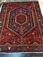 Full view of Persian Touserkan wool rug showing design and colors