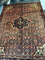 Full view of the Hosseinabad rug showing color and pattern