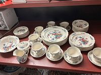 Group view of entire Wedgwood Williamsburg Potpourri set showing plates, bowls, cups, saucers, sugar bowl, creamer, platter