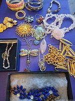All jewellery items laid out on purple background