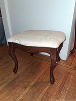 Overall view of footstool showing frame, legs, seat