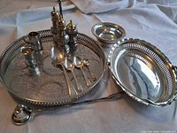 Group shot of all silver plated items on cloth