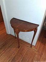 Full front view of demi-lune table against wall