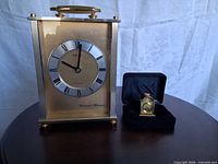 Seiko mantel clock and miniature Widdop clock side by side for scale