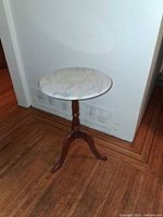 Full view of side table showing marble top and wooden pedestal