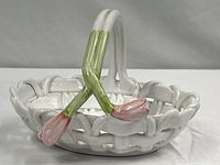Front view showing woven bowl and crossed stem handle with tulip buds