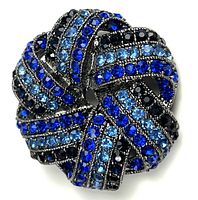 Front view of round swirl brooch with blue rhinestones