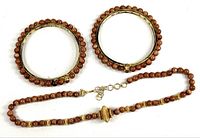 Necklace and two bracelets laid flat showing overall design
