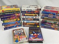 All VHS tapes arranged in three stacks with two sealed titles in front