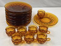 stack of plates and row of cups showing full lot