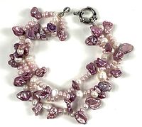 Full view of three-strand purple and pink freshwater pearl bracelet
