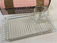 Tray with cup displayed on ribbed surface