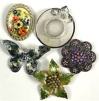 Group shot of all five brooches