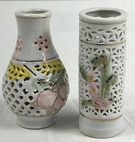 Both miniature openwork porcelain vases side by side