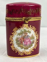 Front view showing courting couple scene, burgundy glaze, gold gilt, ornate clasp