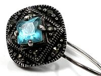 Front view of one earring showing blue stone and marcasite detailing