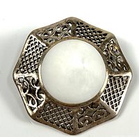 Front view showing mother of pearl center and filigree silver frame