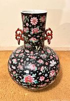 Full view of vase showing shape, floral decoration, and handles