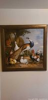 Full view of framed bird scene wall art hung on wall