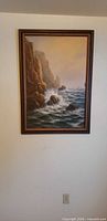 Full view of framed seascape painting on wall