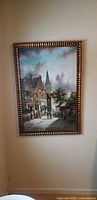 front view of framed European street scene painting