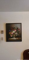 Full view of framed floral still life painting on wall